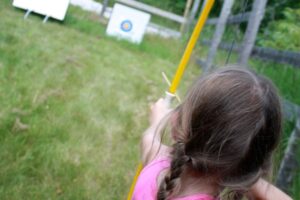 This is an image of a girl practicing her archery skills at SMC.