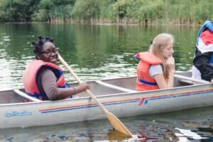 This is a picture of children enjoying themselves on a canoe at SMC.